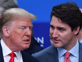 In this file photo taken on Dec. 4, 2019, U.S. President Donald Trump (L) talks with Prime Minister Justin Trudeau during the plenary session of the NATO summit at the Grove hotel in Watford, U.K., northeast of London.