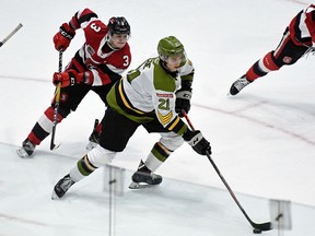 Brandon Coe of the North Bay Battalion skates against Teddy Sawyer and Adam Varga of the Ottawa 67's in the teams' Ontario Hockey League game at TD Place on Feb. 9, 2020.