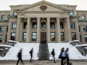 Students walk past Tabaret Hall at the University of Ottawa. February 12, 2020.