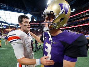 Jarrett Stidham of the Auburn Tigers converses with Jake Browning of the Washington Huskies after their 21-16 win at Mercedes-Benz Stadium on September 1, 2018 in Atlanta, Georgia.