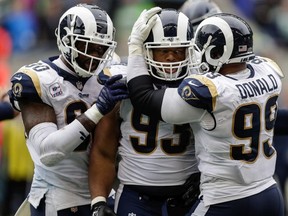 Defensive tackle Ndamukong Suh #93 of the Los Angeles Rams celebrates a sack with teammates in the second half against the Seattle Seahawks at CenturyLink Field on October 7, 2018 in Seattle, Washington.
