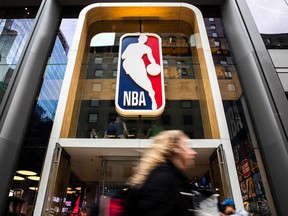 A pedestrian walks past an NBA store on March 12, 2020 in New York City.