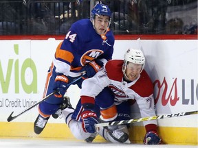 Jean-Gabriel Pageau of the New York Islanders checks Brett Kulak of the Montreal Canadiens into the boards during the first period at the Barclays Center on March 3, 2020.