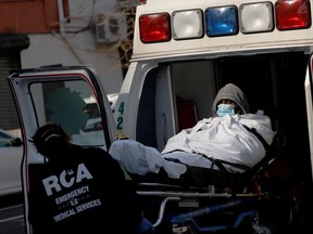 EMT's load a patient into an ambulance as health workers continued to test people for coronavirus disease (COVID-19) outside the Brooklyn Hospital Center in Brooklyn, New York City, March 27, 2020. (REUTERS/Andrew Kelly/File Photo)