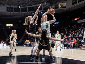 Kali Pocrnic of the Ravens draws an offensive charge foul from Kyla Shand of the Huskies in the first half of Thursday night's quarterfinal.