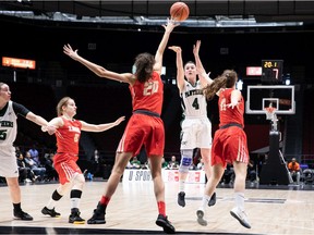 Jenna Mae Elsworth of the Panthers shoots over Lea Dominique (20) and Maude Archambault (11) of the Rouge et Or during the women's bronze-medal game on Sunday. Elsworth finished with 24 points