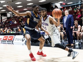 Omar Shiddo of the Mustangs, right, tries to drive to the basket against Grant Audu of the Thunderbirds during the men's bronze-medal game on Sunday.