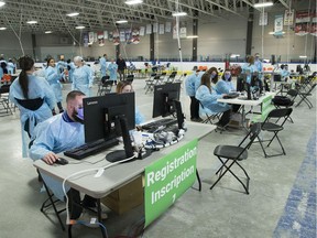 Public health workers wait for patients at the assessment centre at Brewer arena prior to the public opening on Friday.