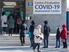 March 15, 2020 - People line up at the COVID-19 Assessment Centre at Brewer Park Arena.