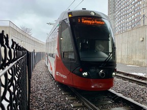 A train on the Confederation Line arrives at the Lees Station.