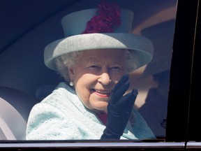 In this file photo taken on April 21, 2019, Britain's Queen Elizabeth II waves from her car after attending the Easter Mattins Service at St. George's Chapel, Windsor Castle.