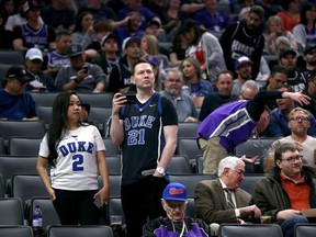 Fans react after it was announced that the game between the New Orleans Pelicans and the Sacramento Kings was postponed at the Golden 1 Center on Wednesday, March 11, 2020.