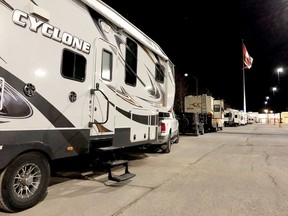 A line of recreational vehicles sits at the south end of the Walmart parking lot in Brockville on Sunday night.