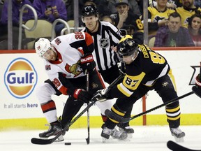 Ottawa Senators winger Connor Brown (left) and Penguins captain Sidney Crosby battle for the puck on Tuesday night in Pittsburgh. (Charles LeClaire/USA TODAY Sports)