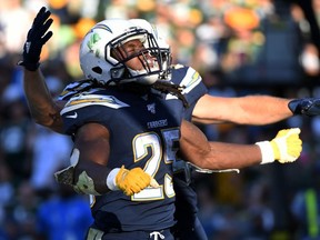 Los Angeles Chargers running back Melvin Gordon celebrates with fullback Derek Watt after scoring on a one yard touchdown run against the Green Bay Packers during the fourth quarter at Dignity Health Sports Park.