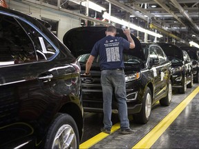 Ford Edges sit on a production line at the Ford Assembly Plant in Oakville, Ont., on Thursday, February 26, 2015. (THE CANADIAN PRESS/Chris Young)