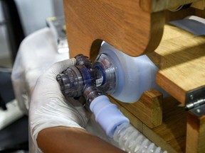A volunteer works on a ventilator for use during the COVID-19 outbreak.