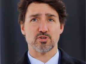 Canada's Prime Minister Justin Trudeau speaks to news media outside his home in Ottawa on March 25, 2020.