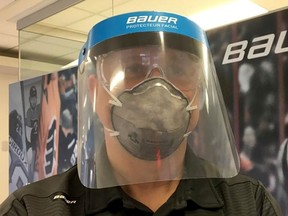 A staff member wears a medical visor produced by Bauer Hockey for medical staff fighting the spread of coronavirus disease (COVID-19) in Exeter, N.H., in a picture released March 25, 2020.