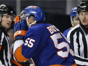 New York Islanders defenceman Johnny Boychuk leaves the ice holding his face after being injured against the Montreal Canadiens during the third period at Barclays Center.