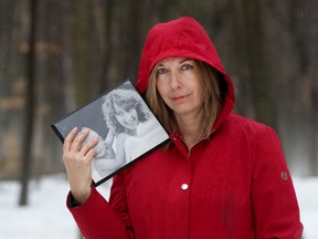 Dina Bell-Laroche holds a photo of her sister Tracy Bell, who died of cancer.