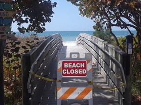 A beach is closed in Florida - to go with snowbirds fly home story. John Owens