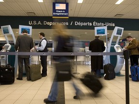 Travellers check in at Terminal 2 at Toronto's Pearson International airport for flights to the U.S. , in this Jan. 22, 2007, file photo.