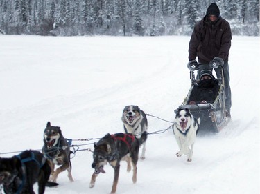 DELINE, N.W.T. NOVEMBER 19,  2012 --- OTTAWA SENATOR Marc Methot gives Winnipeg Jet Grant Clitsome a wild and chilly ride, driving a dogsled team in Deline.