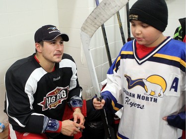 YELLOWKNIFE, N.W.T. NOVEMBER 18,  2012 --- A number of Ottawa Senators and other NHL players arrived in Yellowknife in the Northwest Territories Sunday to begin their Northern Lights Dream Tour, which will include three exhibition games in Yellowknife, Inuvik, and Whitehorse (Yukon). Here, Jordan Tootoo signs autographs and sticks in the dressing room after the game.