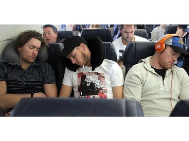 WHITEHORSE, YUKON. NOVEMBER 22,  2012 --- Ottawa Senators (from left) Zack Smith, Peter Regin and Chris Neil catch some much-needed sleep on the long flights home from the north.  The Northern Lights Dream Tour wound up Wednesday with a final game in Whitehorse, Yukon, followed by long flights home on Thursday for the players - many with three connections and 15 to 20 hours in the air.  (JULIE OLIVER/OTTAWA CITIZEN/) #111075. Ken Warren.
