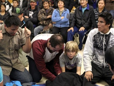 DELINE, N.W.T. NOVEMBER 19,  2012 ---  Here, Chris Phillips and his son Ben play traditional hand games with the people in the community centre in Deline, NWT, while on the Norther Lights Dream Tour.