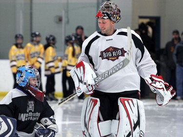 YELLOWKNIFE, N.W.T. NOVEMBER 18,  2012 --- A number of Ottawa Senators and other NHL players arrived in Yellowknife in the Northwest Territories Sunday to begin their Northern Lights Dream Tour, which will include three exhibition games in Yellowknife, Inuvik, and Whitehorse (Yukon). Here, Senators' goalie Craig Anderson meets his mini match as local children escort players onto the ice before the game.