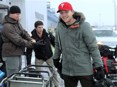 YELLOWKNIFE, N.W.T. NOVEMBER 18,  2012 --- A number of Ottawa Senators and other NHL players arrived in Yellowknife in the Northwest Territories Sunday to begin their Northern Lights Dream Tour, which will include three exhibition games in Yellowknife, Inuvik, and Whitehorse (Yukon). Here, Ottawa Senator Zack Smith (centre) carries his bags to a waiting truck at the Yellowknife airport as fellow player Marc Methot (left) bundles up for the cold weather.