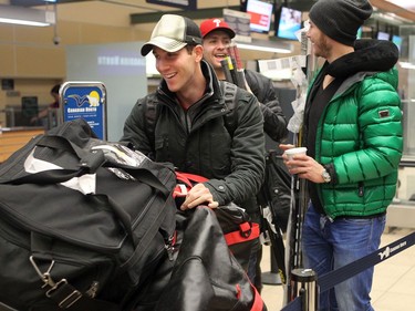 YELLOWKNIFE, N.W.T. NOVEMBER 18,  2012 --- A number of Ottawa Senators and other NHL players arrived in Yellowknife in the Northwest Territories Sunday to begin their Northern Lights Dream Tour, which will include three exhibition games in Yellowknife, Inuvik, and Whitehorse (Yukon). Here, the day starts early with a morning flight from Edmonton, Alberta to Yellowknife as Strength Coach/consultant Rob Mouland (left), Ottawa players Zack Smith (centre) and Peter Regin, carry bags and sticks to the check-in.