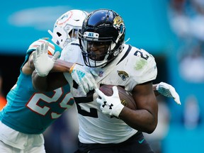 Jaguars’ Leonard Fournette avoids a tackle from Dolphins’ Minkah Fitzpatrick. Fournette could be on the trading block.
