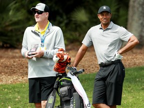 Tiger Woods of the United States (right) and caddie Joe LaCava look on during a practice round for The PLAYERS Championship on The Stadium Course at TPC Sawgrass on March 13, 2019 in Ponte Vedra Beach, Florida. (Michael Reaves/Getty Images)