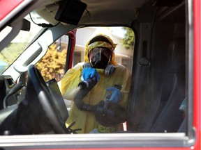 A worker with CleanHarbors sprays disinfectant inside a Marin County Fire Department ambulance on April 14, 2020 in Greenbrae, California.