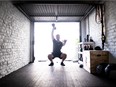 Files: A man trains in his garage. With gyms and exercise facilities are closed due to the COVID-19 pandemic, athletes are finding ways to maintain their fitness at home and in ways that respect social distancing rules.