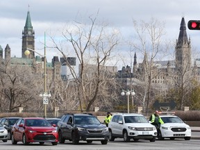 Gatineau police officers control the traffic leaving from and arriving into Gatineau to Ottawa on the Portage Bridge.