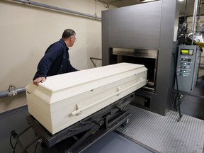 A casket is placed in position for a cremation