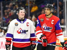 Alexis Lafreniere #11 of Team White and Quinton Byfield #55 of Team Red talk during the third period of the 2020 CHL/NHL Top Prospects Game at FirstOntario Centre on January 16, 2020.