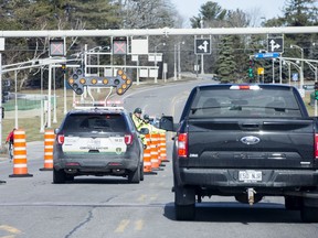 Contrôle routier Québec officers stop vehicles entering Quebec on the Champlain Bridge.