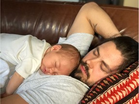 Redblacks player Antoine Pruneau sleeping with baby Charles.