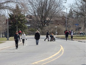 Files--Pedestrians and cyclists enjoy some freedom on the road as a portion of the Queen Elizabeth Driveway is closed to vehicles.