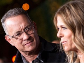 In this file photo taken on March 16, 2020 actors Tom Hanks (L) and his wife actress/singer Rita Wilson attend "JONI 75: A Birthday Celebration" Live at the Dorothy Chandler Pavilion in Los Angeles.
