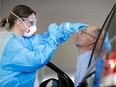 FILE: A medical staff takes a sample.