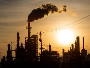 The sun sets behind smoke rising from the LyondellBasell-Houston Refining plant in Houston, Texas, on April 20, 2020.