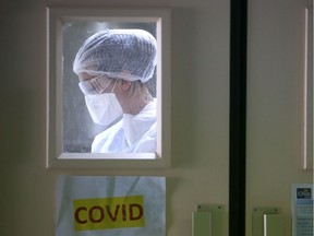 A nurse wearing protective gear is at work in the COVID-19 area.