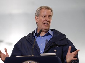 New York City Mayor Bill de Blasio speaks at an indoor training center at the USTA Billie Jean King United States Tennis Center, which will be partially converted into temporary hospital during the COVID-19 outbreak, in the Queens borough of New York City, New York, U.S., on March 31, 2020. (REUTERS/Stefan Jeremiah)