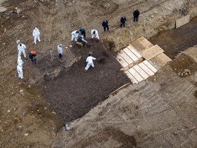 Drone pictures show bodies being buried on New York's Hart Island where the Department of Corrections is dealing with more burials overall, amid the COVID-19 outbreak in New York City, Friday, April 9, 2020.